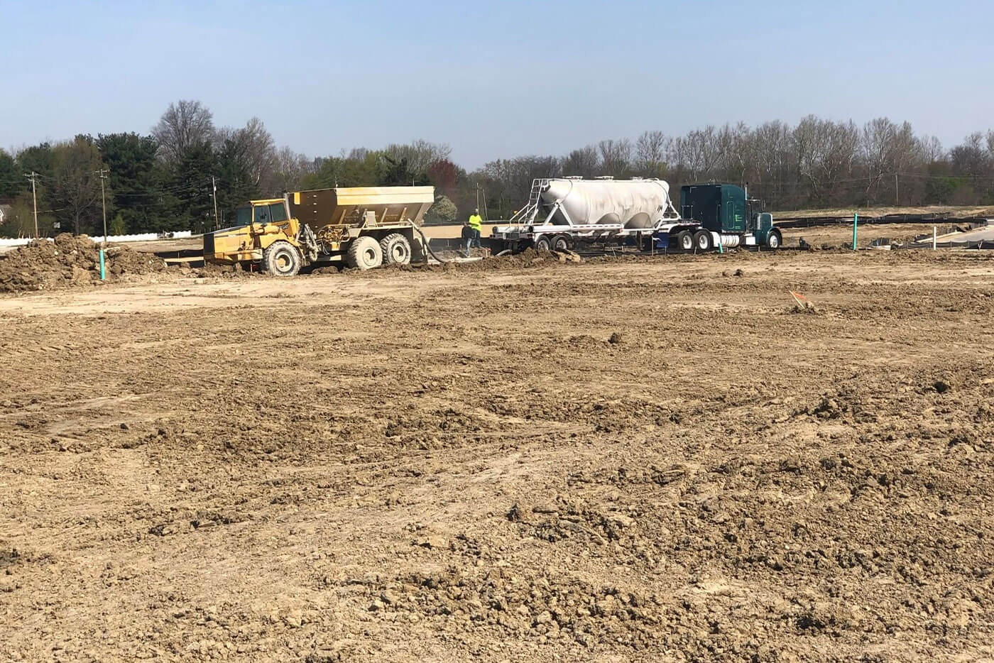 United Excavating crew and trucks working a jobsite