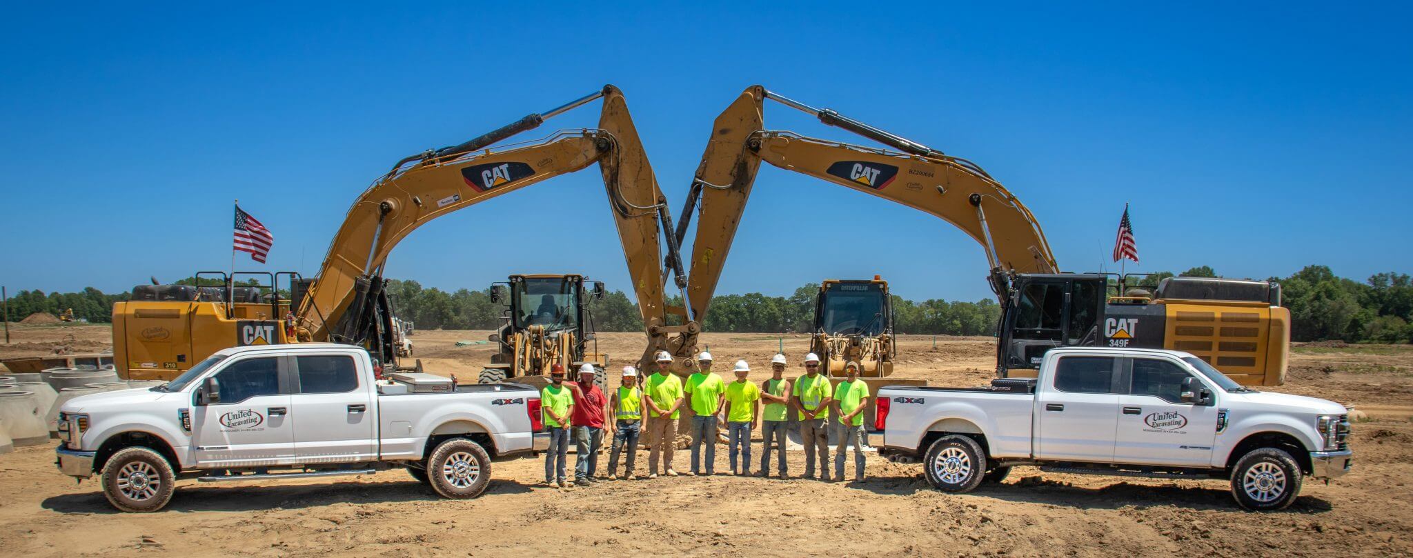 United Excavating team and trucks on a jobsite