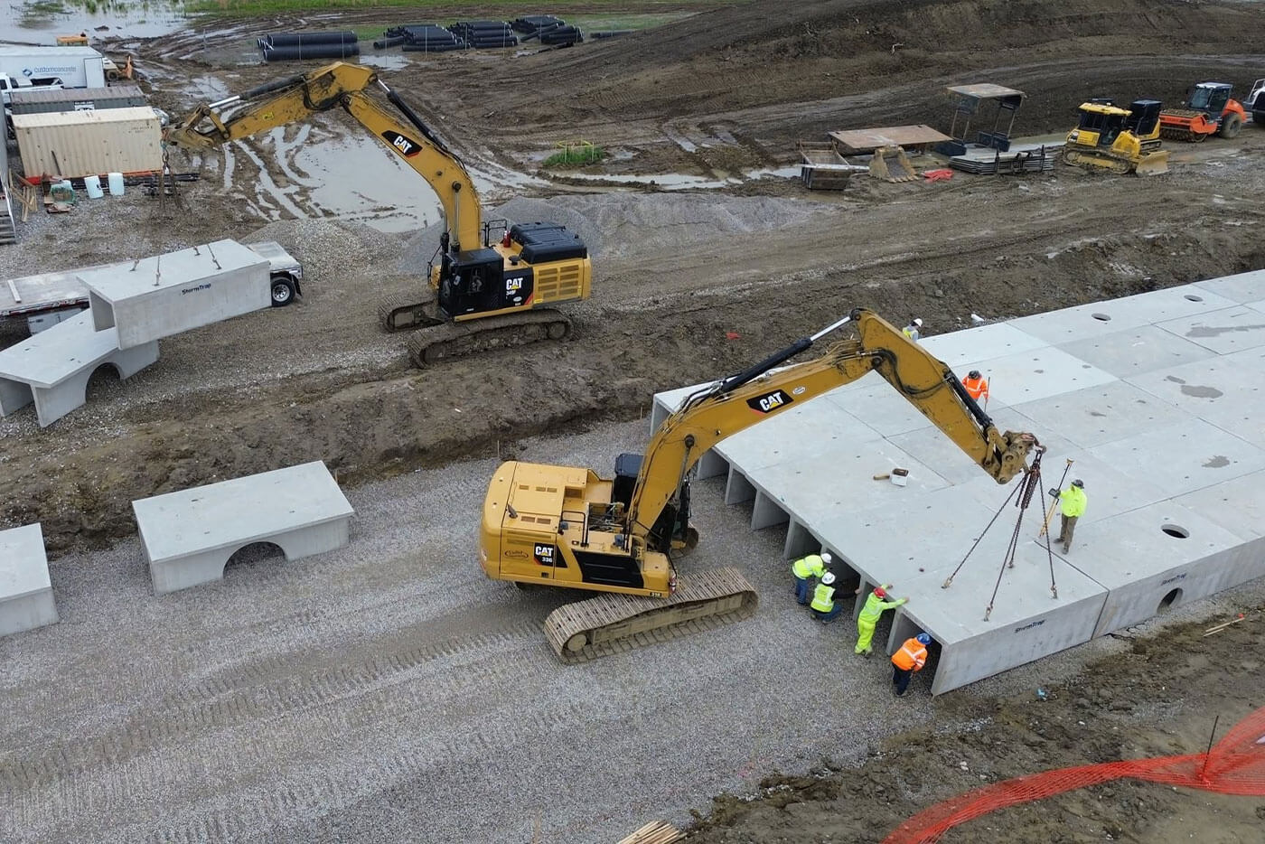 Aerial view of crew installing a precast underground utility vault